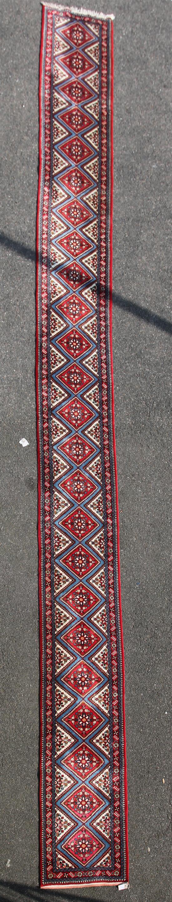 A Persian long runner, 25ft 9in by 2ft 4in.